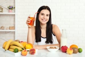 a woman drinking fruit juice